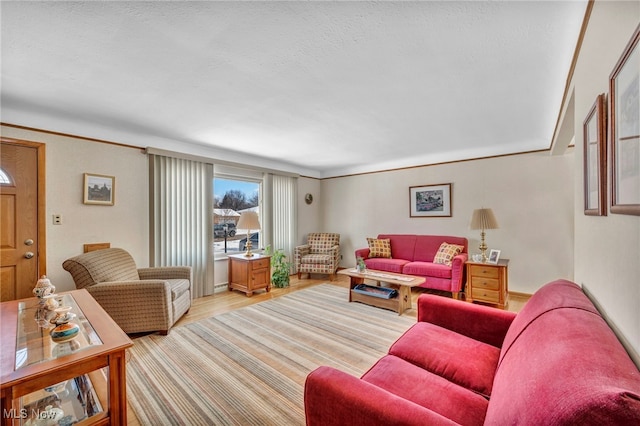 living room with light wood-type flooring and crown molding