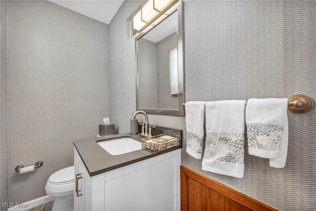 bathroom featuring toilet and vanity