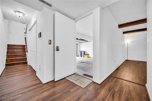 corridor with hardwood / wood-style floors and beam ceiling