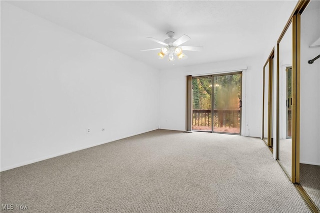 spare room with ceiling fan and carpet