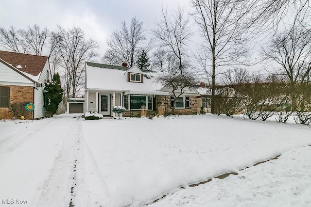 view of front of house featuring a garage and an outdoor structure