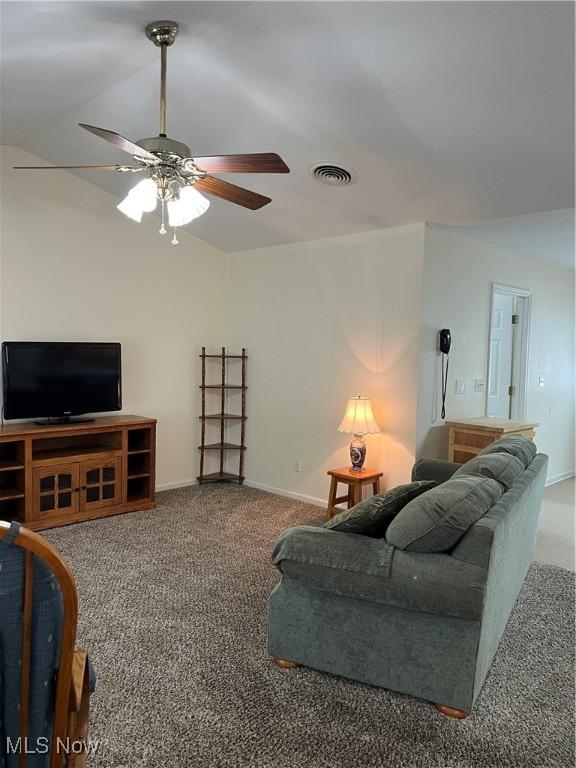 carpeted living room featuring ceiling fan and lofted ceiling