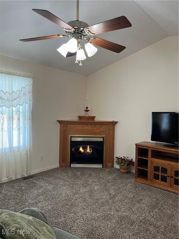 unfurnished living room with carpet floors, lofted ceiling, and ceiling fan