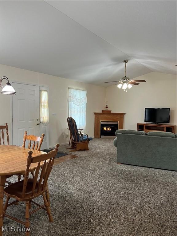 carpeted living room with vaulted ceiling and ceiling fan