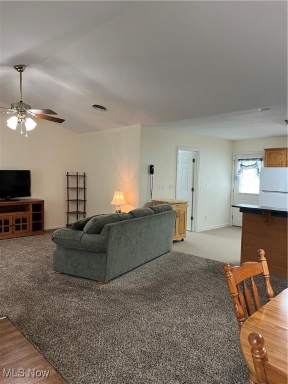 living room featuring light wood-type flooring and ceiling fan