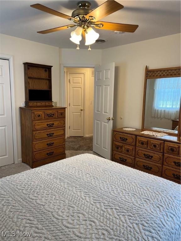 carpeted bedroom with ceiling fan