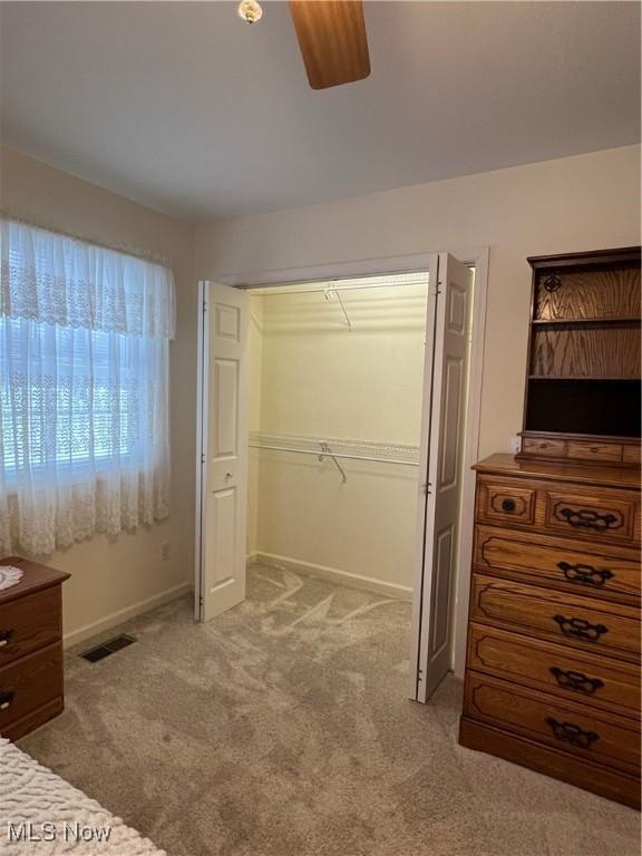 carpeted bedroom with a closet