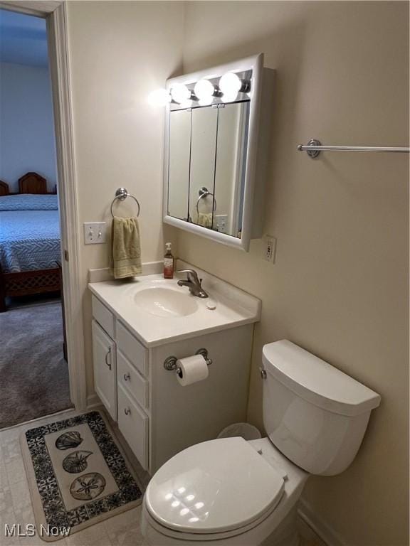 bathroom featuring toilet and vanity