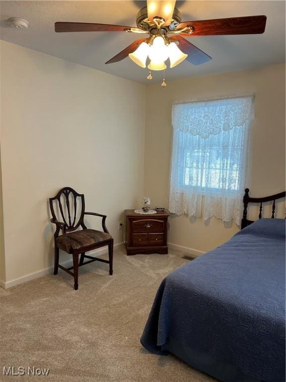 bedroom with ceiling fan and light colored carpet