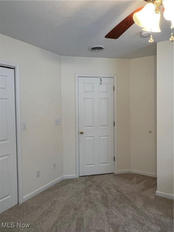 unfurnished room featuring ceiling fan and carpet floors