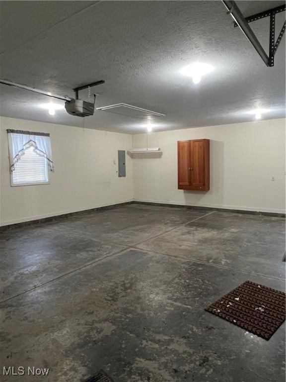 garage featuring electric panel and a garage door opener