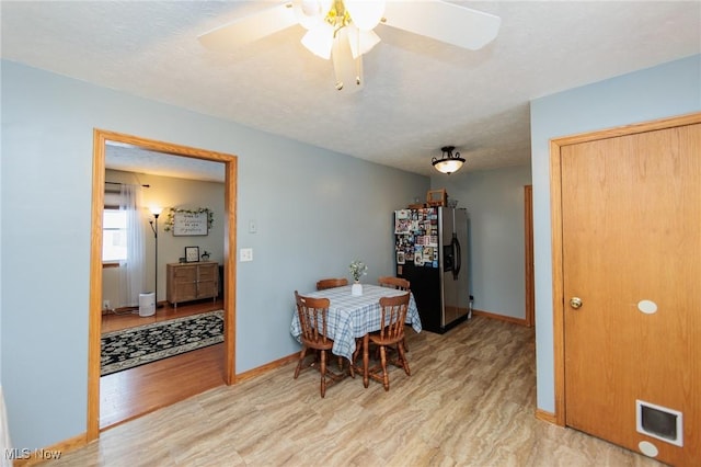 dining room with ceiling fan and light hardwood / wood-style floors