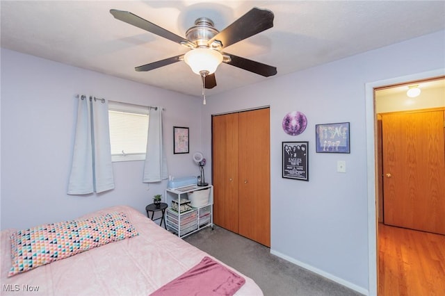 carpeted bedroom featuring ceiling fan and a closet