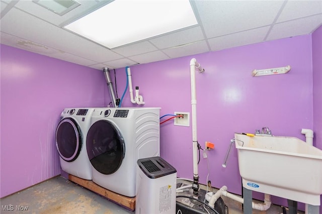 clothes washing area with independent washer and dryer and sink