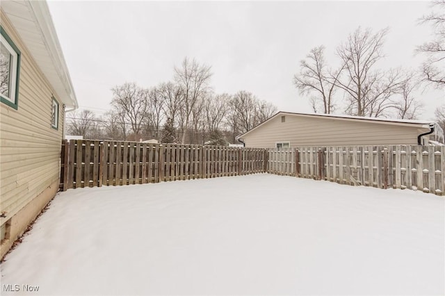 view of yard layered in snow