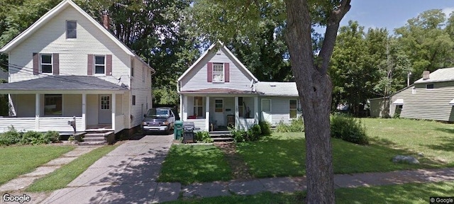 farmhouse inspired home with covered porch and a front yard