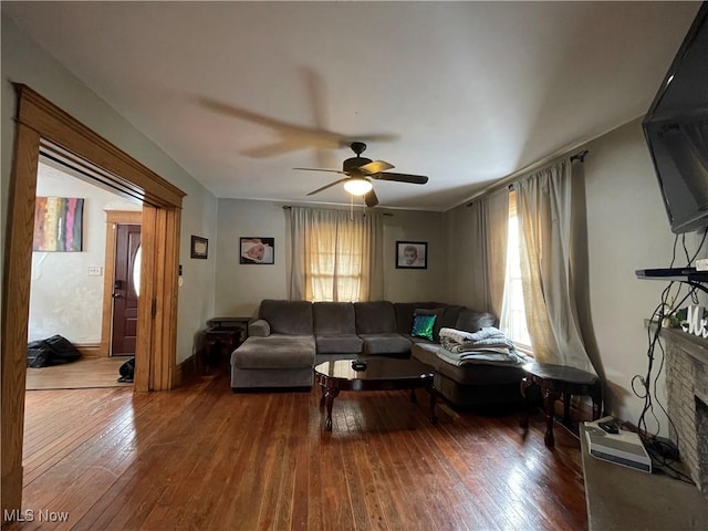 living room with ceiling fan and dark hardwood / wood-style floors