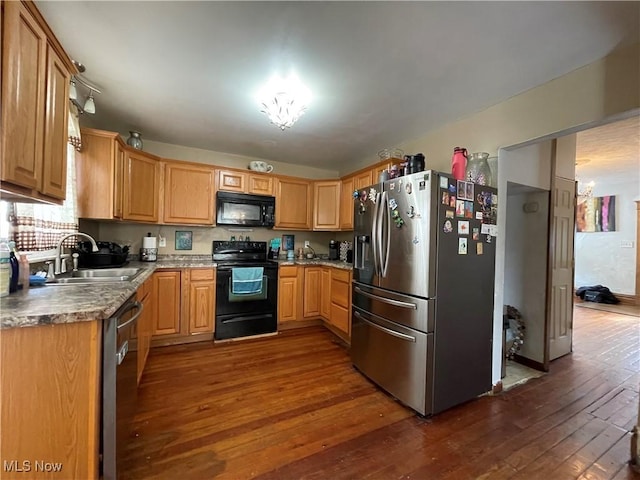 kitchen featuring sink, black appliances, and dark hardwood / wood-style floors