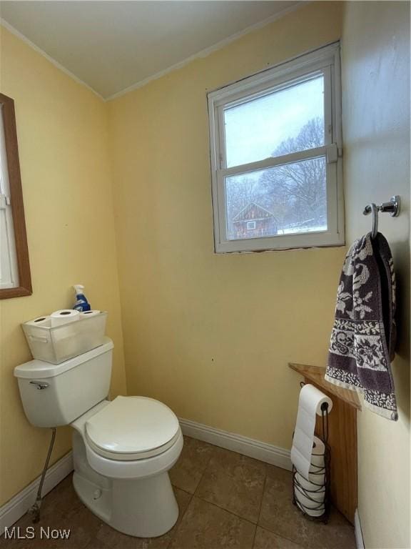 bathroom with ornamental molding, tile patterned floors, and toilet