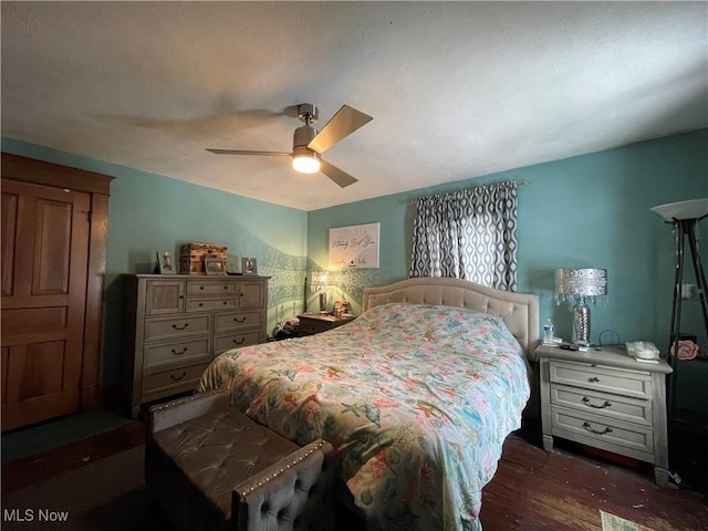 bedroom with ceiling fan and dark hardwood / wood-style flooring