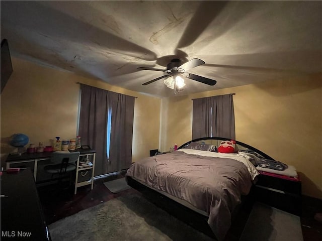 bedroom with dark wood-type flooring and ceiling fan