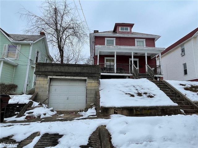 view of front of home featuring a garage and a porch