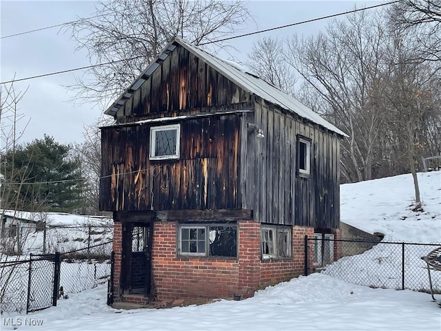 snow covered property with an outdoor structure