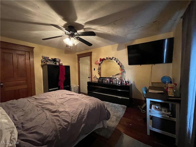 bedroom with dark wood-type flooring and ceiling fan