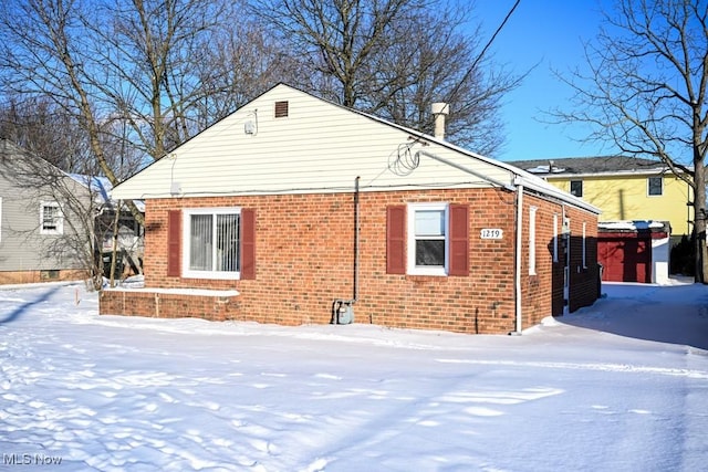 view of snow covered rear of property