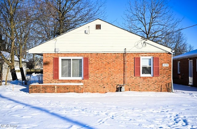 view of snow covered back of property