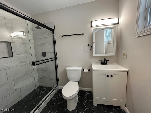 bathroom with toilet, tile patterned flooring, a shower with door, and vanity