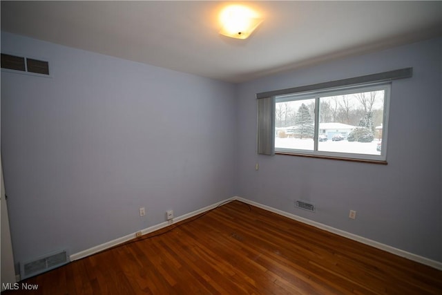 empty room featuring dark hardwood / wood-style floors