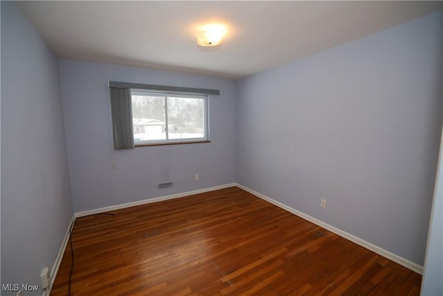 empty room featuring dark hardwood / wood-style flooring