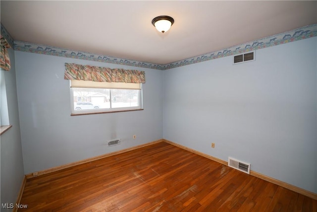 spare room with wood-type flooring