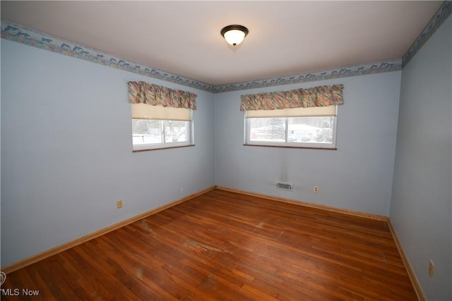 spare room featuring hardwood / wood-style flooring