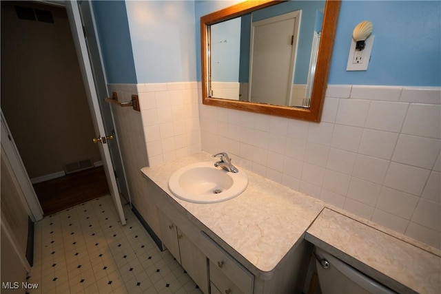 bathroom with tile walls and vanity