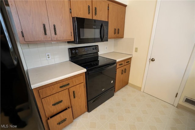 kitchen featuring tasteful backsplash and black appliances