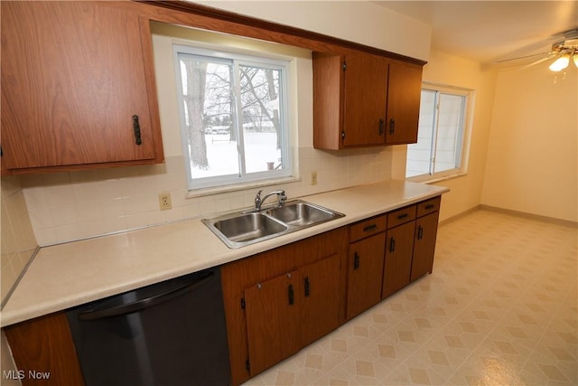 kitchen with decorative backsplash, sink, black dishwasher, and ceiling fan