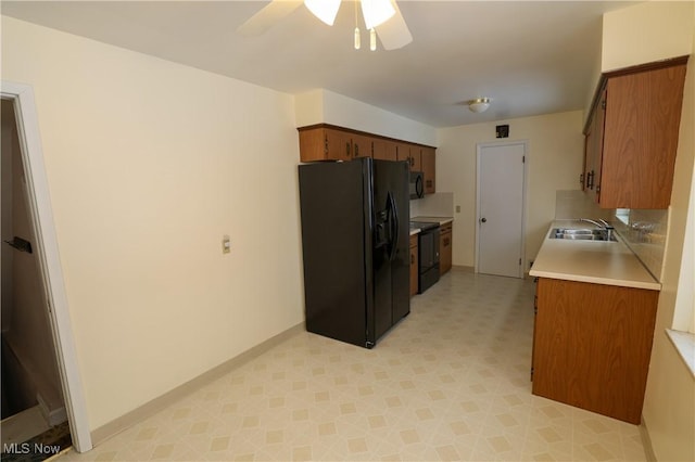 kitchen with black appliances, ceiling fan, and sink