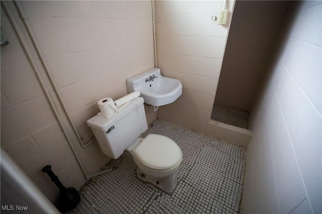 bathroom featuring toilet and tile patterned floors