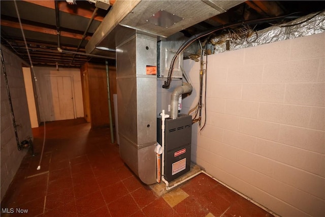 utility room featuring heating unit