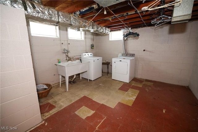 basement featuring washing machine and dryer and sink