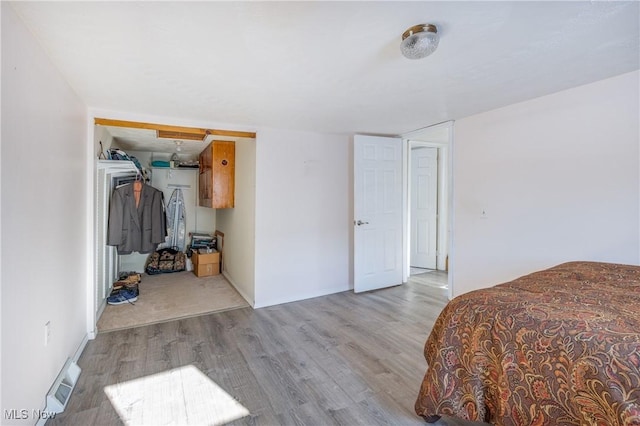 bedroom featuring a closet and light hardwood / wood-style flooring