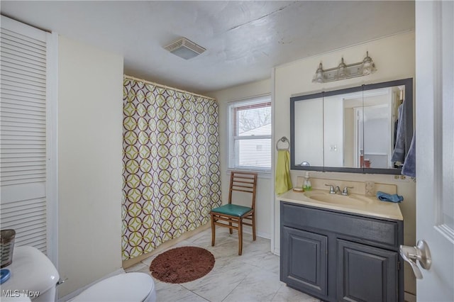 bathroom featuring toilet, tile patterned floors, and vanity