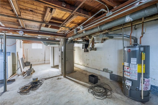 basement featuring water heater and washer / clothes dryer