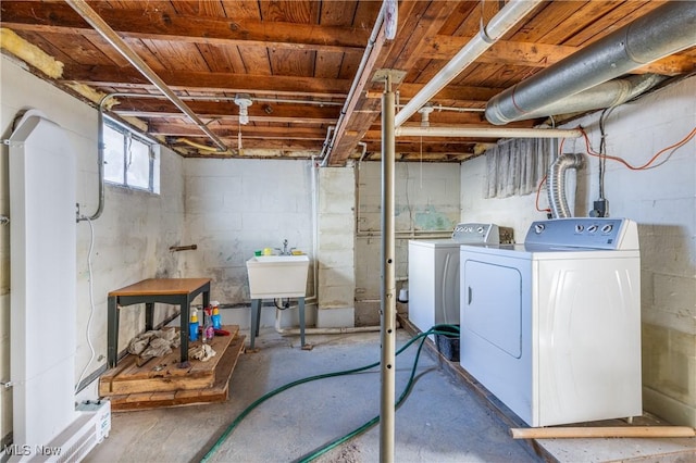 basement featuring washer and dryer and sink