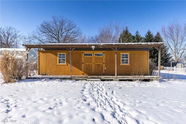 snow covered house with an outdoor structure