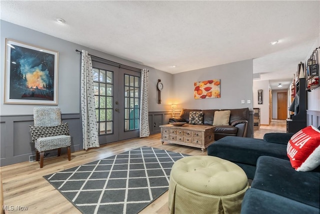 living room with french doors and hardwood / wood-style floors