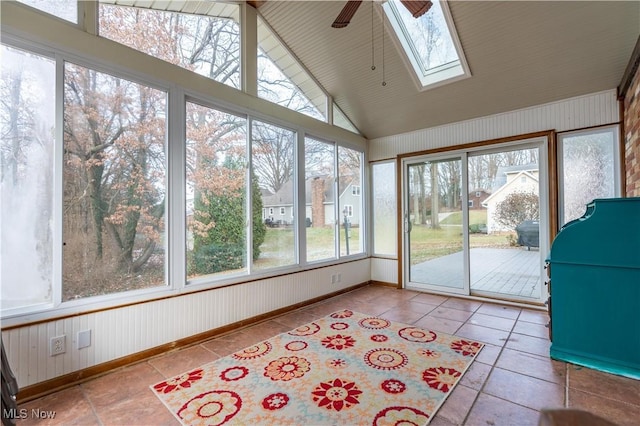 unfurnished sunroom featuring ceiling fan and vaulted ceiling with skylight