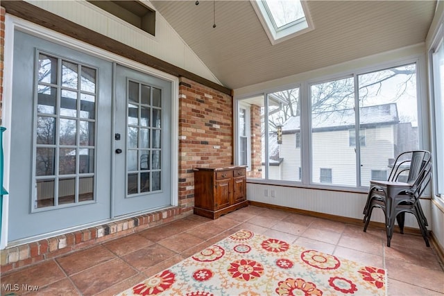 sunroom featuring lofted ceiling with skylight